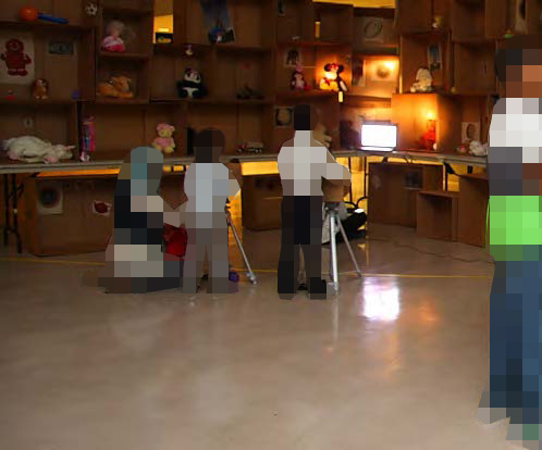 Pixelated mom kneeling next to her son while he manipulates the search interface